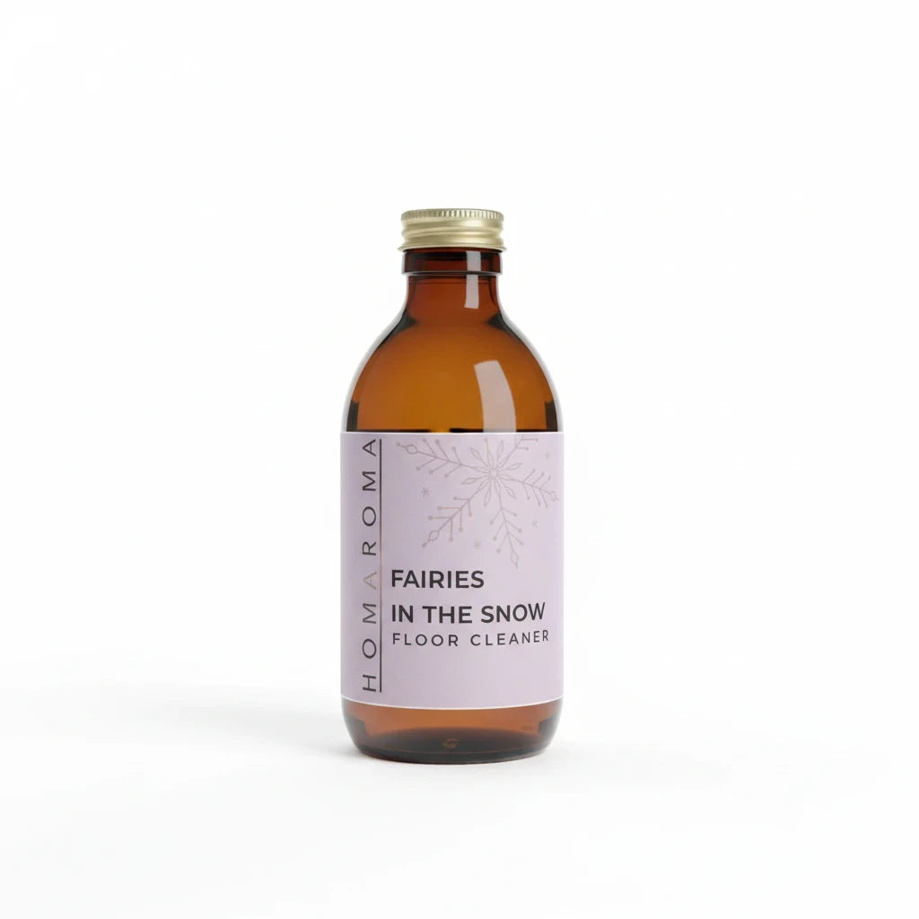 Homaroma Fairies in the Snow concentrated floor cleaner in an amber glass bottle with a light purple label
