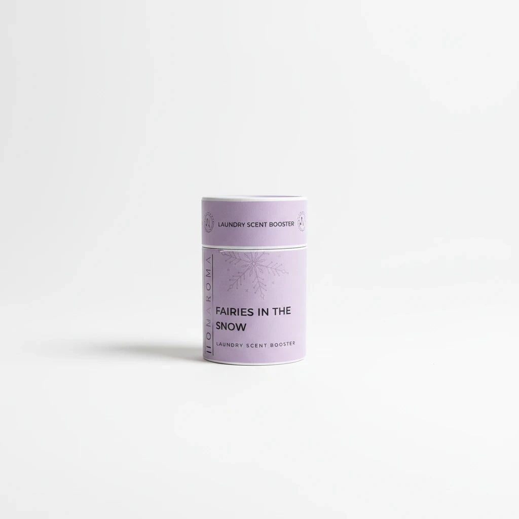 Homaroma Fairies in the Snow laundry scent booster in a light purple cylindrical container with snowflake design.