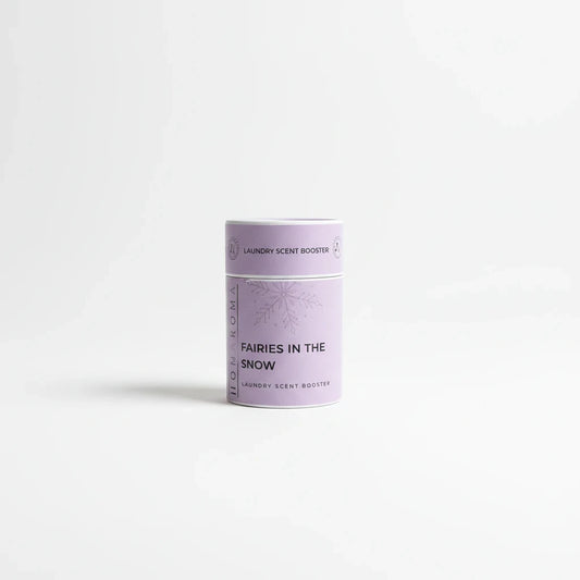Homaroma Fairies in the Snow laundry scent booster in a light purple cylindrical container with snowflake design.