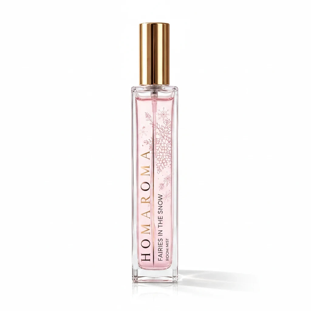 Homaroma Fairies in the Snow room mist in a tall glass bottle with pink liquid and gold cap, featuring snowflake art.