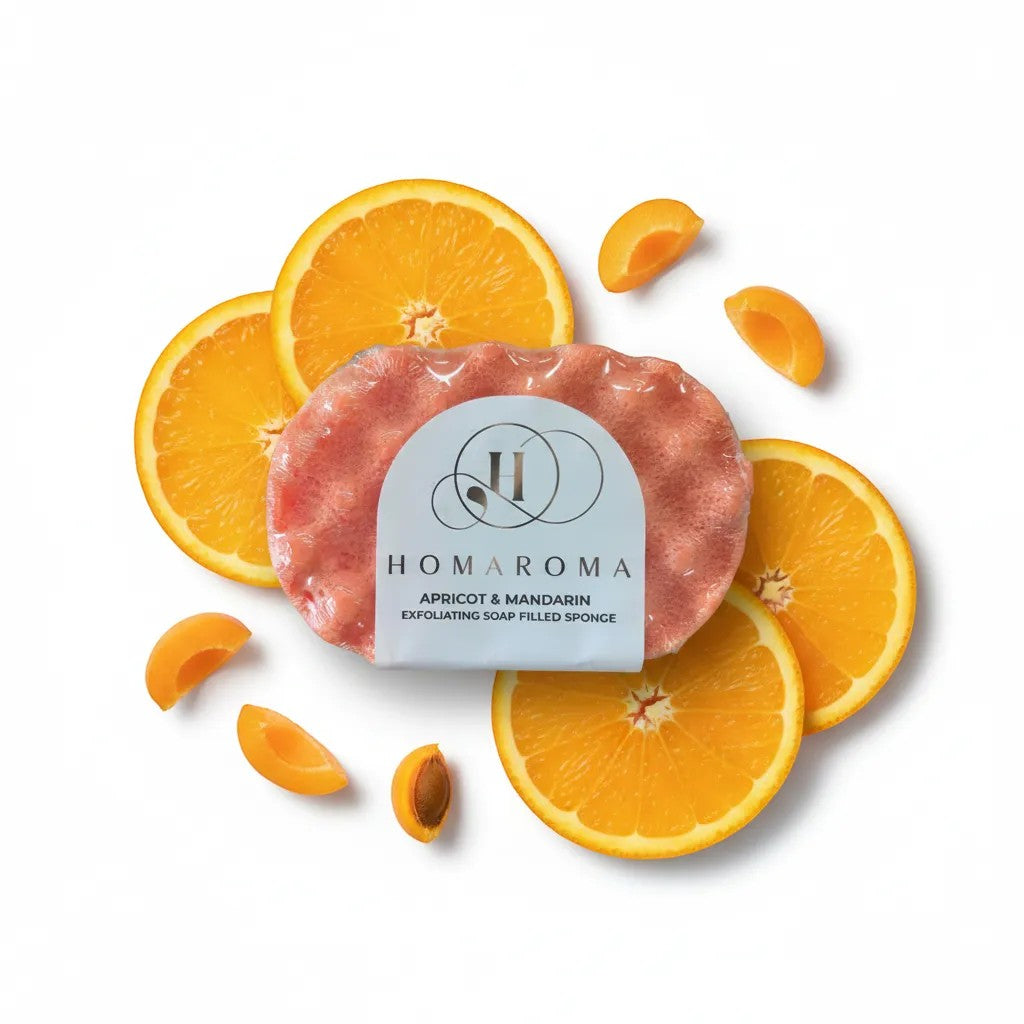 Homaroma Apricot & Mandarin exfoliating soap-filled sponge with fresh apricot slices and orange slices.