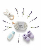 Homaroma Bedtime Baby exfoliating soap-filled sponge with lavender, baby booties, and a bunny rattle.