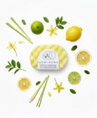 Homaroma Citronella & Lemongrass soap-filled sponge with dual-sided texture, surrounded by fresh lemons, limes, lemongrass stalks, and green leaves.