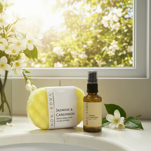 Homaroma Jasmine & Cardamom exfoliating soap sponge and body mist set in amber bottle.