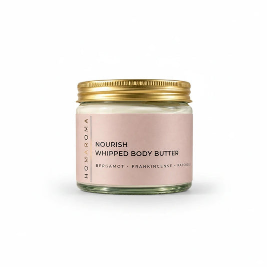 Homaroma Nourish whipped body butter in a glass jar with a gold lid and soft pink label on a white background.